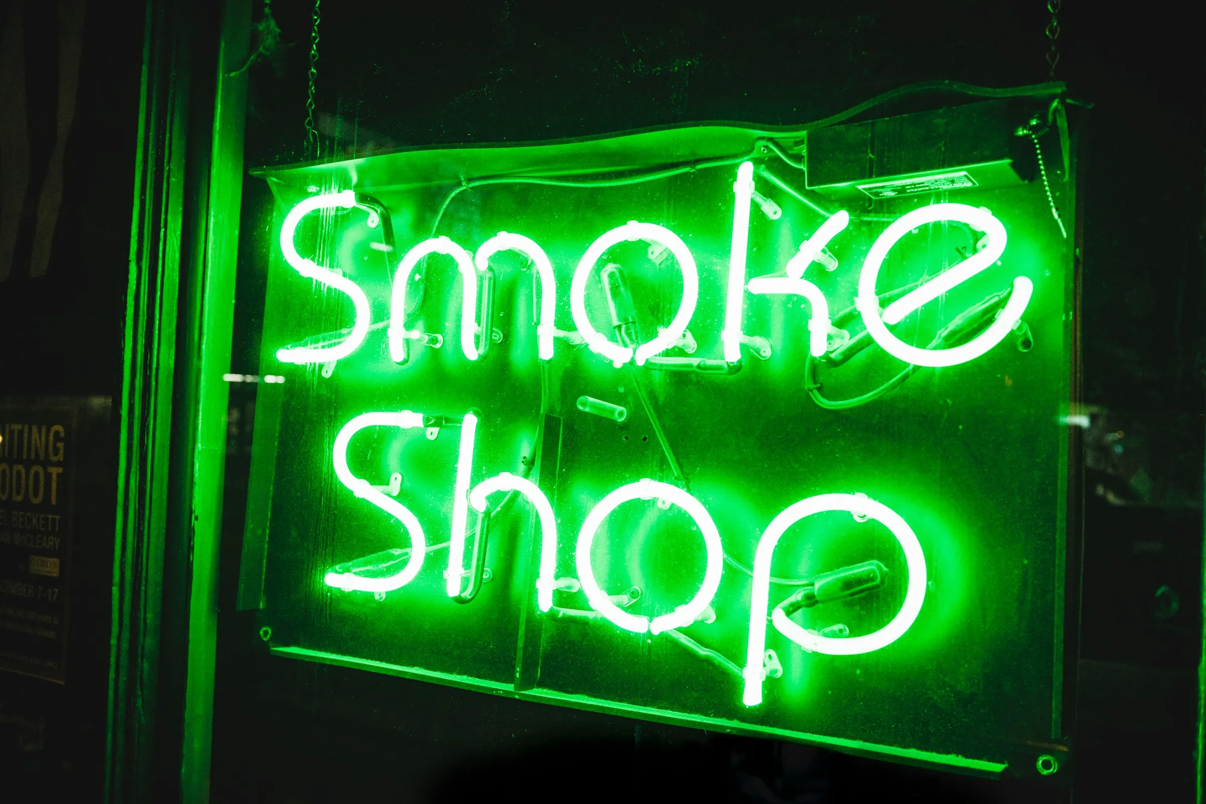 A lit smoke shop neon sign